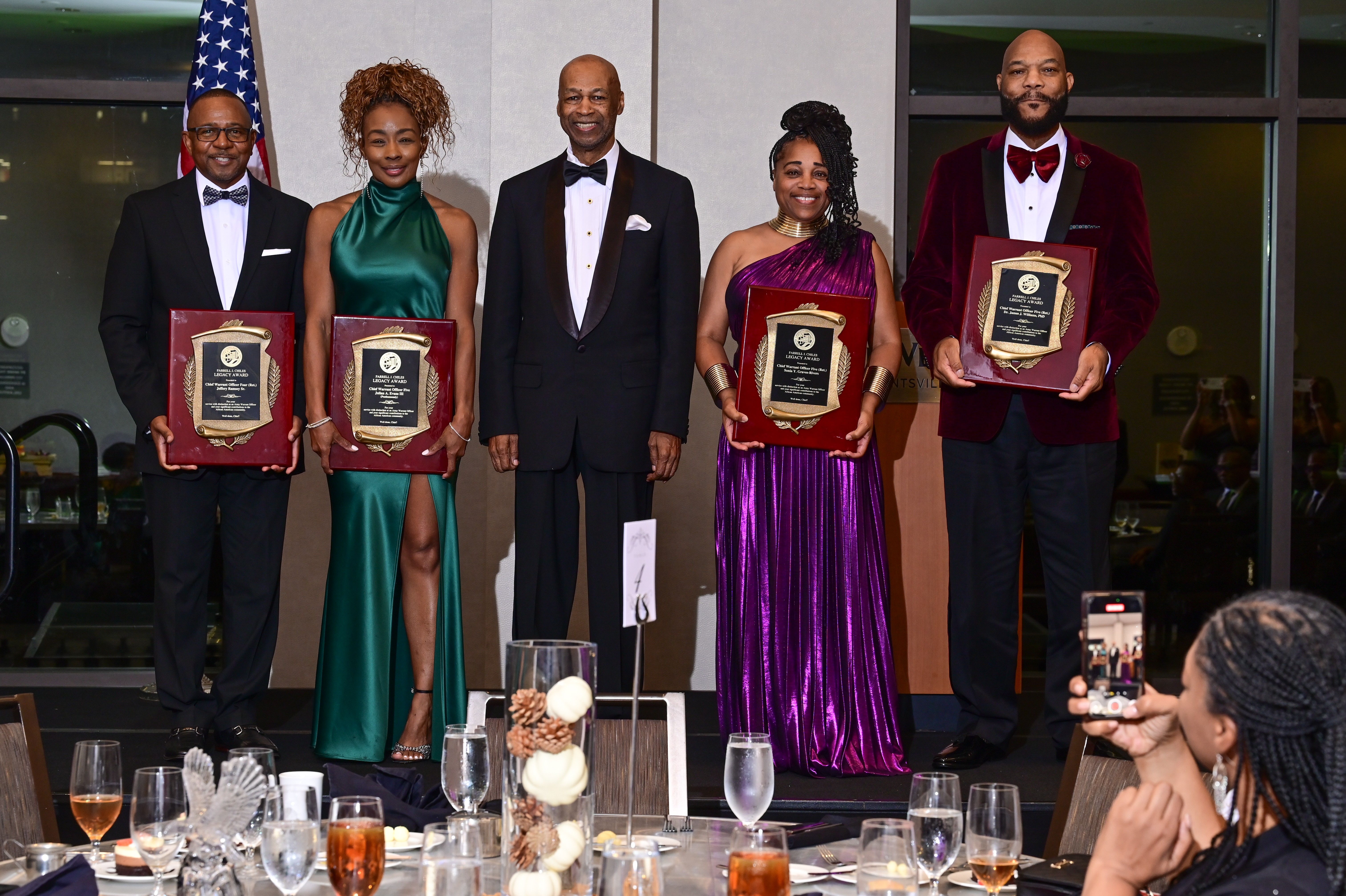 An honoree receiving the Legacy Award on stage